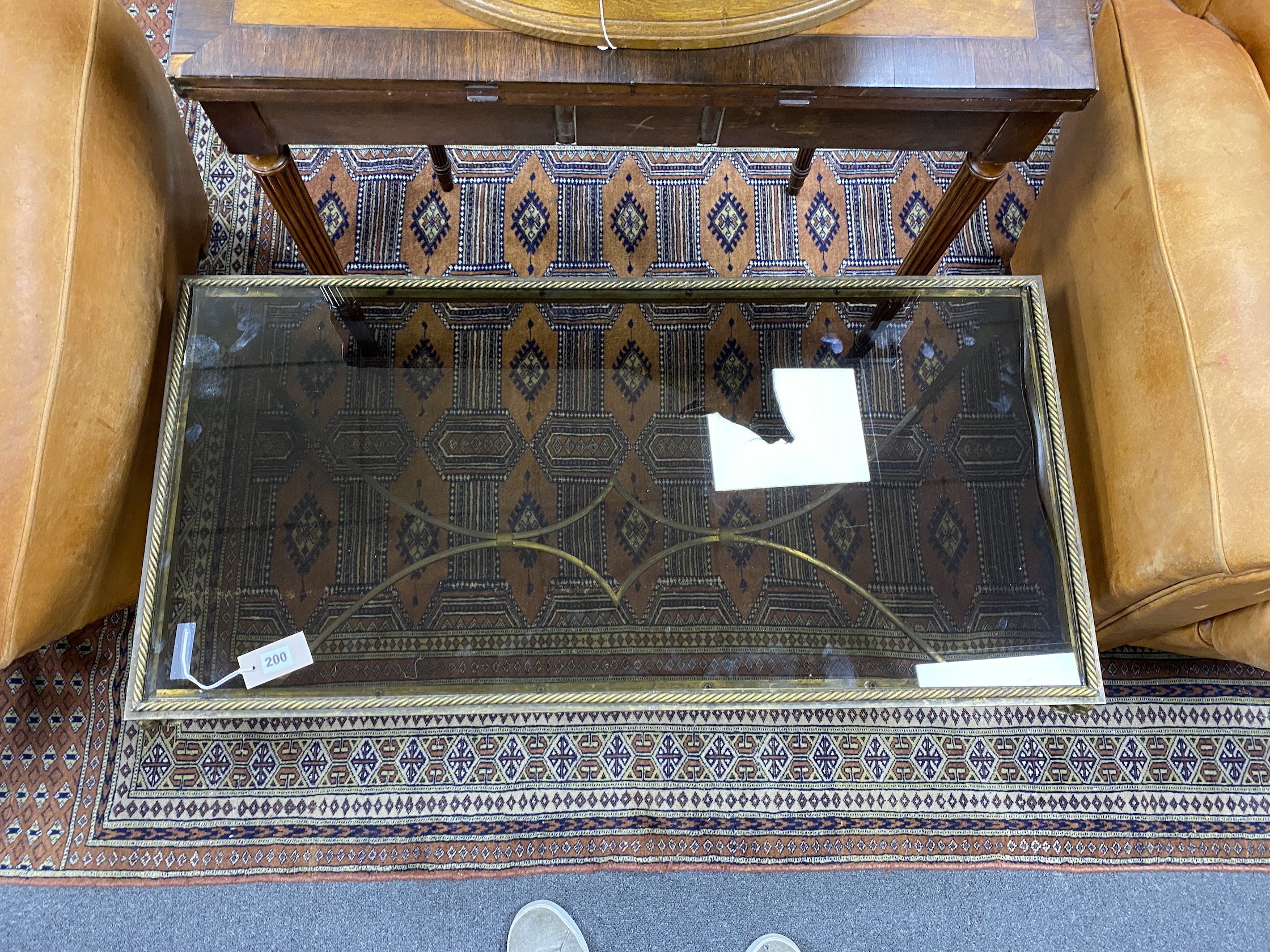 A mid century rectangular gilt metal ram's head glass top coffee table, width 104cm, depth 51cm, height 41cm